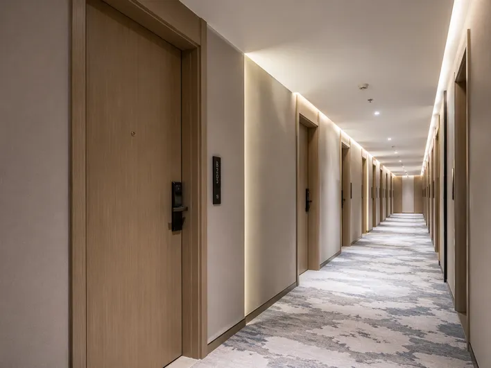 Architectural commercial doors installed in hotel corridor showing custom finish and fire-rated construction