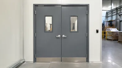 Heavy-duty double commercial doors for warehouse personnel access