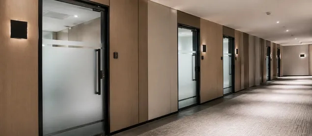 Full glass commercial doors in hotel corridor — hospitality and retail application with custom frosted configuration