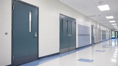 Institutional construction project showing commercial steel doors in a school corridor