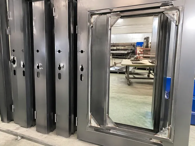 Metal door frame construction showing welded gusset corners and hardware prep