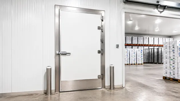 Reinforced warehouse door in a cold storage food distribution facility