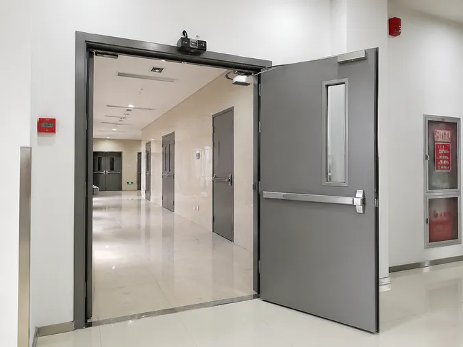 EUWOO automatic fire door with electromagnetic hold-open device installed in commercial corridor