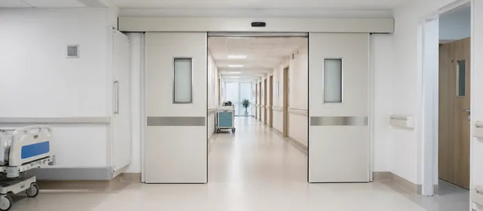 Automatic fire doors installed in hospital corridor for healthcare fire compartmentation