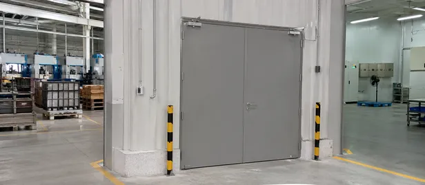 Industrial fire door installed at manufacturing facility zone boundary