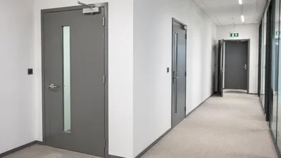 Interior fire doors installed in commercial office building stairwell and corridor compartmentation