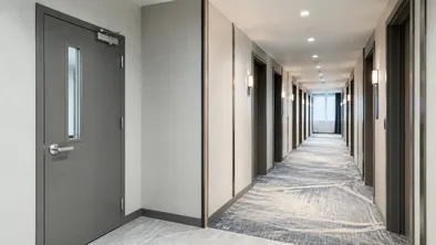 Interior fire doors for hotel corridor compartmentation and stairwell access in hospitality development