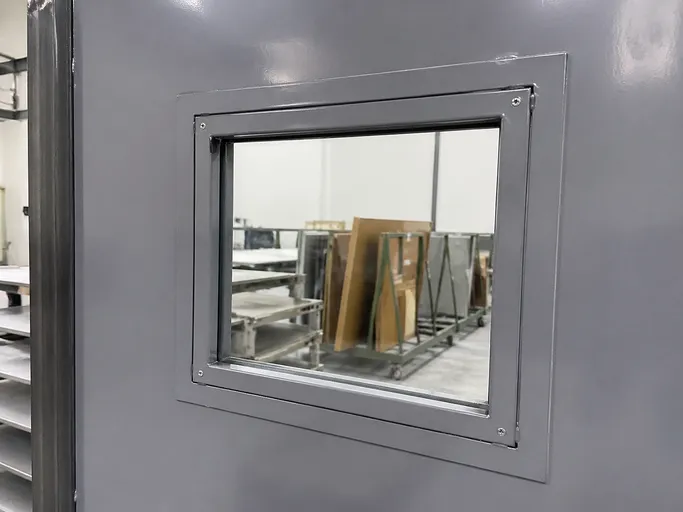 Office fire door vision panel with welded steel sub-frame — fire-rated glazing detail