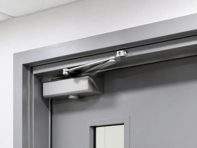EN 1154 overhead closer mechanism on a self closing fire door assembly