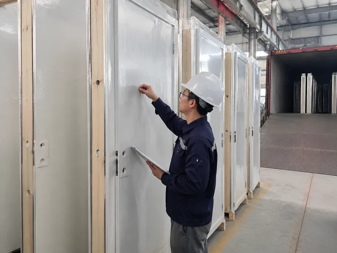 EUWOO QC inspector performing pre-shipment outgoing inspection on steel door units before container loading