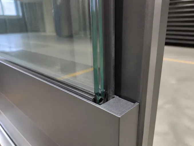 Captured glazing channel with neoprene gasket — glass retention detail on EUWOO steel security door