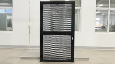 Expanded steel mesh security door in reinforced frame