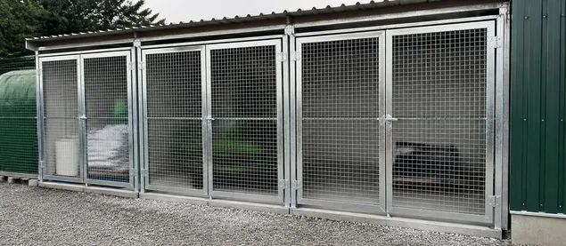 Mesh security door on agricultural storage or equipment yard enclosure