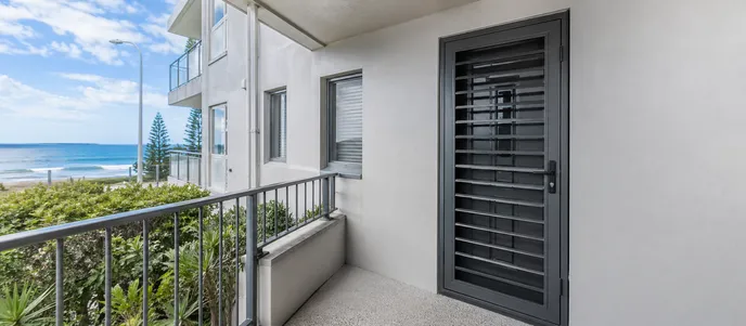 Metal security door on coastal apartment building in salt air environment