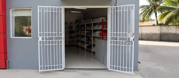 Double-leaf security grill doors on commercial shopfronts in tropical markets