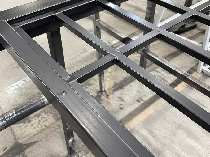 Close-up of flat bar grill infill welded intersections and SPCC steel frame construction