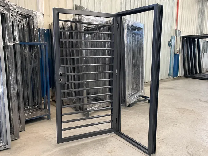 Steel security grill door showing open flat bar grill pattern and frame construction