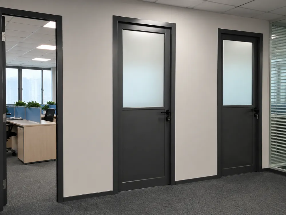 Glass steel door installed in commercial office fit-out with frosted upper panel